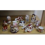 Ten Royal Crown Derby paperweights, a miniature Derby cup and a cream jug