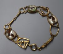 A 1920's 14k yellow metal and Essex crystal set bracelet, the three crystals depicting, a horse, a