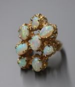 A 14k and eight stone cabochon opal set modernist dress ring, size M/N