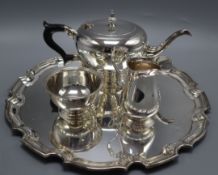 A modern silver three piece tea set and matching circular tray by Harrods Ltd, Birmingham, 1964,