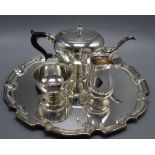 A modern silver three piece tea set and matching circular tray by Harrods Ltd, Birmingham, 1964,