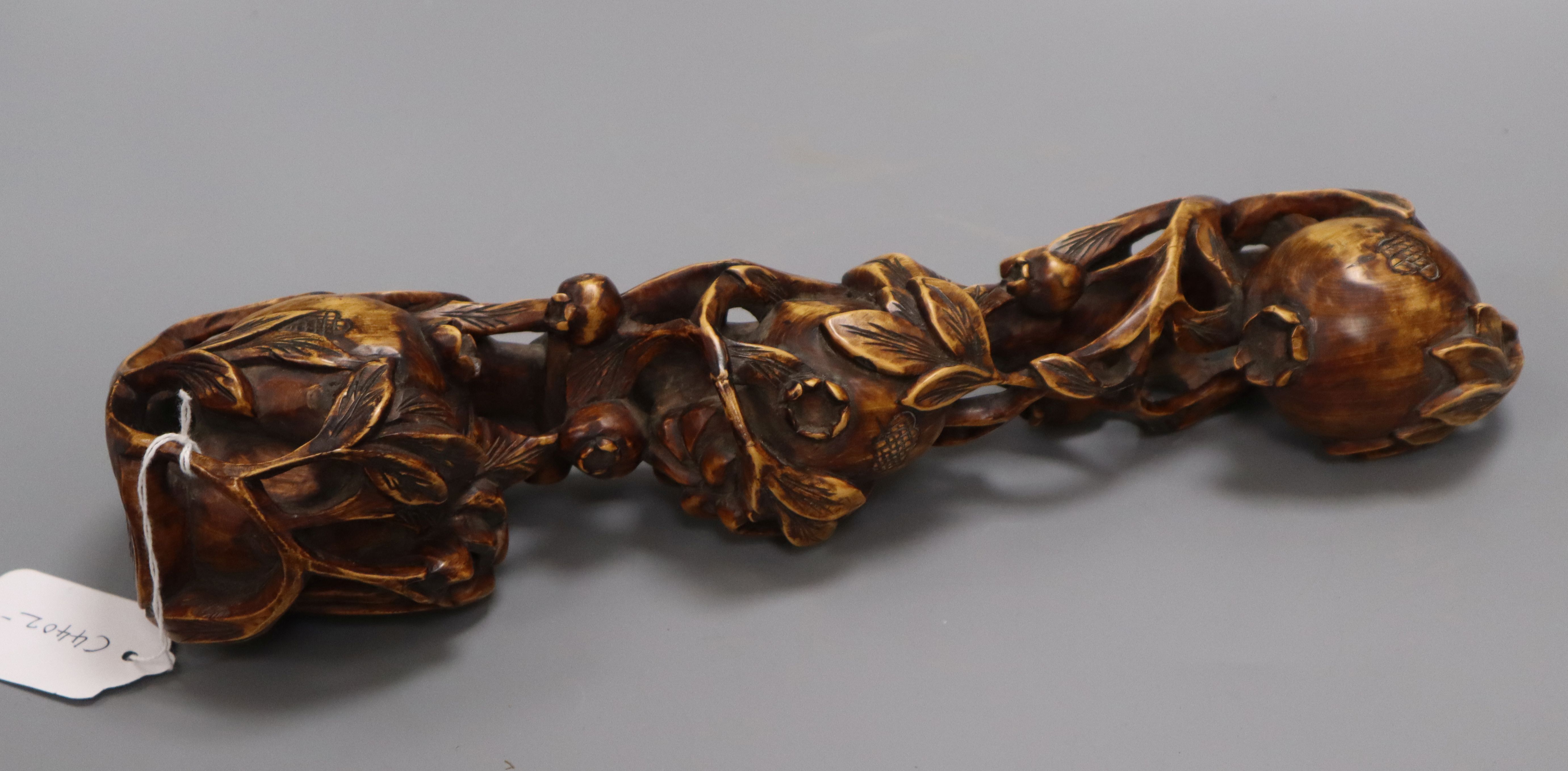 A Chinese carved wood pomegranate ruyi sceptre length 35cm