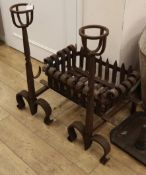 A pair of wrought iron dogs and a fire basket