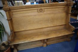 A late Victorian light oak hall seat W.220cm