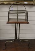 An early 20th century oak and tubular brass four division tripod newspaper stand W.40cm