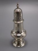 A George III silver caster/pepperette, by John Delmester, London, 1766, 13.1cm.