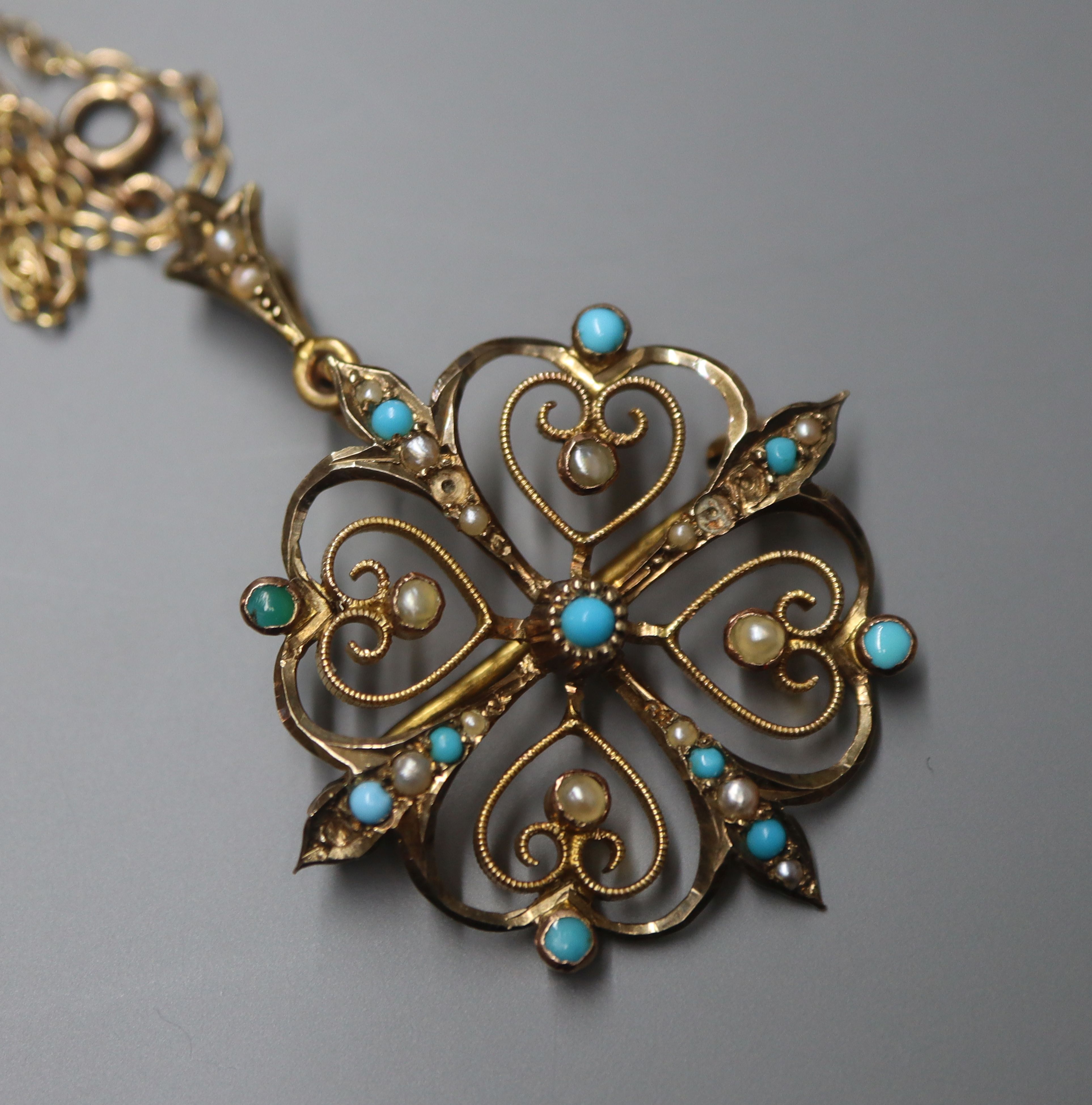 An early 20th century 9ct, turquoise and seed pearl set openwork pendant, on a yellow metal fine