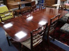 A Regency style mahogany twin pillar dining table Extended 250cm (two spare leaves)