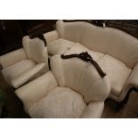 An early 20th century French carved mahogany three piece suite, upholstered in ivory damask