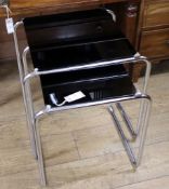 A nest of two mid century black glass and tubular chrome tables, marked Arel (?) W.52cm