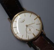 A gentleman's 9ct gold Longines manual wind dress wrist watch, on associated leather strap.