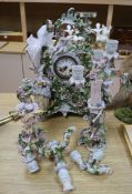 A continental floral encrusted mantel clock and candelabra