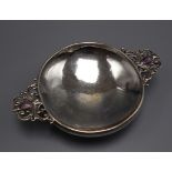 A George V Arts & Crafts silver quaich with cabochon amethyst set pierced handles, John Walker,