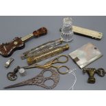 A glass seal, scissors, perfume bottles and mixed collectibles