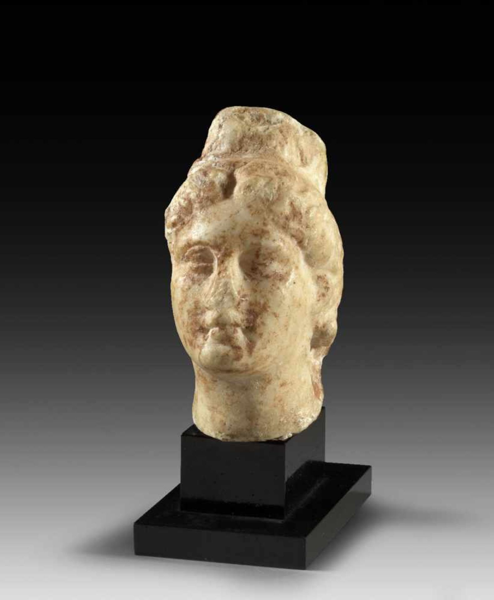 Kopf der Kybele. Hellenistisch, 2. - 1. Jh. v. Chr. H 8,2cm, mit Sockel 11cm. Weißer,