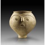 Bulbous sandy clay urn with beaded decor which forms a face. Roman, end of 1st century A.D.