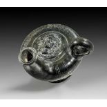 Apulian black-glazed guttus with ribbed corpus and long spout. 2nd half 4th century B.C. Above the