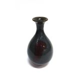 A CHINESE TERRACOTTA VASE of inverted baluaster form with slender flared neck, decorative glaze