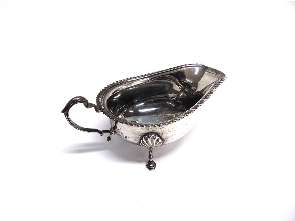 A SILVER SAUCEBOAT by Elkington & Co, Birmingham 1964, with gadrooned rim, scroll handle and on - Image 2 of 2