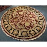 A CIRCULAR RED GROUND CARPET 248cm diameter