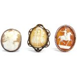 A LATE VICTORIAN SHELL CAMEO BROOCH tagged '9ct'; with two metal mounted cameo brooches