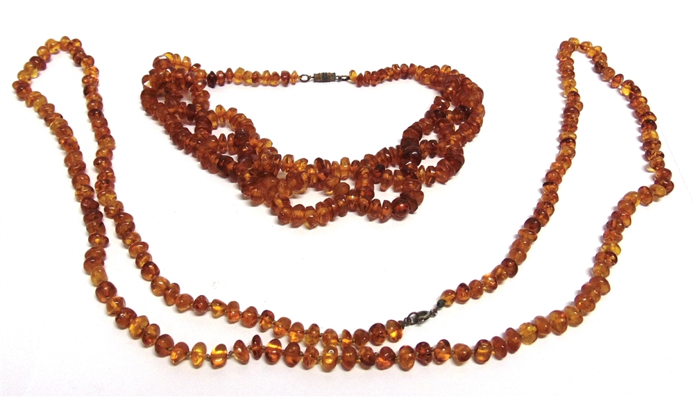 A LONG ROW OF SMALL TUMBLED AMBER BEADS 110cm, long, 33g gross; with an amber tumbled bead