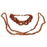 A LONG ROW OF SMALL TUMBLED AMBER BEADS 110cm, long, 33g gross; with an amber tumbled bead