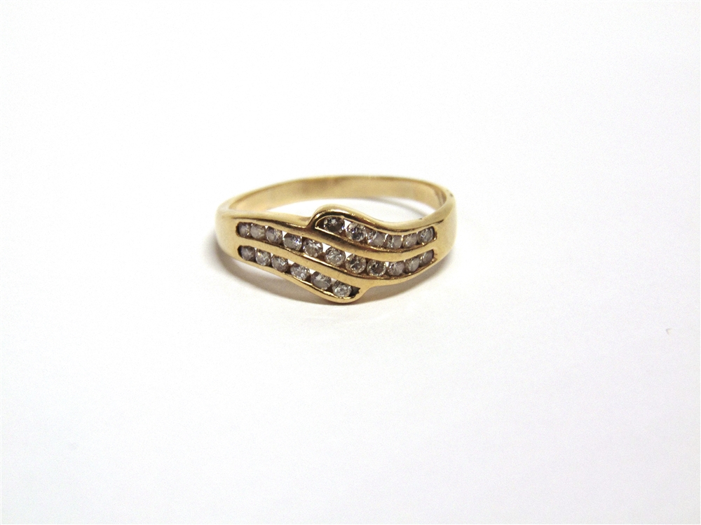 A TWENTY THREE STONE DIAMOND RING stamped '18ct', the brilliant cuts channel set in three rows