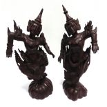 A PAIR OF CARVED HARDWOOD FIGURES modelled as Siamese dancing ladies, 50cm high