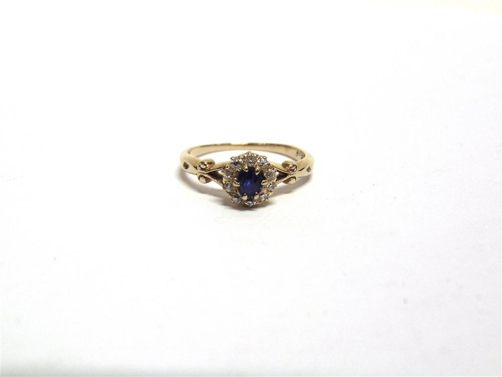 A SAPPHIRE AND DIAMOND CLUSTER RING the yellow split shoulder shank stamped '18ct' and 'H&Co', the - Image 2 of 2