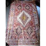 A HAND WOVEN RUG OR WALL HANGING decorated allover with stylised animals, 190cm x 124cm