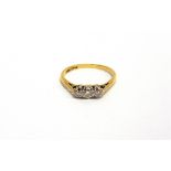 A THREE STONE DIAMOND RING stamped 'Plat 18ct', set with graduated small brilliant cuts, finger size