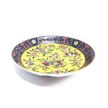 A CHINESE PORCELAIN DISH polychrome enamel foliate decoration on a yellow ground within a blue