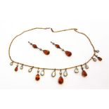 AN EDWARDIAN CITRINE, AQUAMARINE AND SEED PEARL SET FRINGE NECKLACE 42cm long; with a pair of