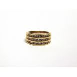 AN 18 CARAT GOLD TWENTY SEVEN STONE DIAMOND RING channel set in three rows with brilliant cuts,