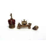 A GROUP OF THREE 9CT GOLD 'CHARM' PENDANTS to include; the gold state Coach (Coronation Coach),