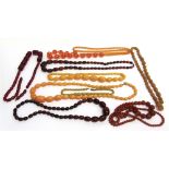 A COLLECTION OF NINE IMITATION AMBER BEAD NECKLACES some early 20th century cellulose, acetate type,