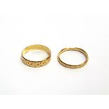 TWO LATE VICTORIAN GOLD WEDDING BANDS comprising a 5mm wide band chased and engraved with flower