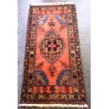 A RED GROUND RUG with central medallion, 87cm x 172cm; and another red ground rug 162cm x 133cm