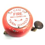 A CAST ALUMINIUM WALL-MOUNTABLE CIRCULAR FIRE BELL by Read & Campbell Ltd, with a bakelite-topped