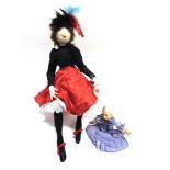 TWO CLOTH DOLLS comprising a character doll modelled as a music hall dancer, 50cm high; and a