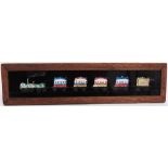 NINE HAND-PAINTED MAHOGANY-FRAMED MAGIC LANTERN STRIP SLIDES the subjects including a steam train;