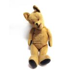 A LARGE GOLD MOHAIR PLUSH TEDDY BEAR with orange glass eyes, a black vertically stitched nose, an