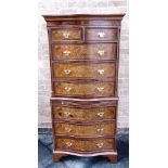 A REPRODUCTION BURR WALNUT VENEERED SERPENTINE FRONT CHEST ON CHEST the upper section with two short