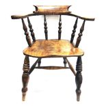 A SMOKER'S BOW ARMCHAIR on turned supports with H-shaped stretcher base