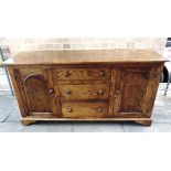 AN OAK SIDEBOARD with three graduated drawers flanked by cupboards, 163cm wide 50cm deep 86cm high