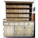 A LARGE PINE DRESSER the base fitted with three drawers above cupboards, 179cm wide 50cm deep