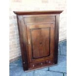 A LARGE PROVINCIAL OAK HANGING CORNER CABINET with inlaid decoration, 92cm wide 124cm high