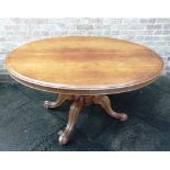 A VICTORIAN MAHOGANY LOO TABLE the oval tilt top 104cm x 137cm, on quatrfoil base