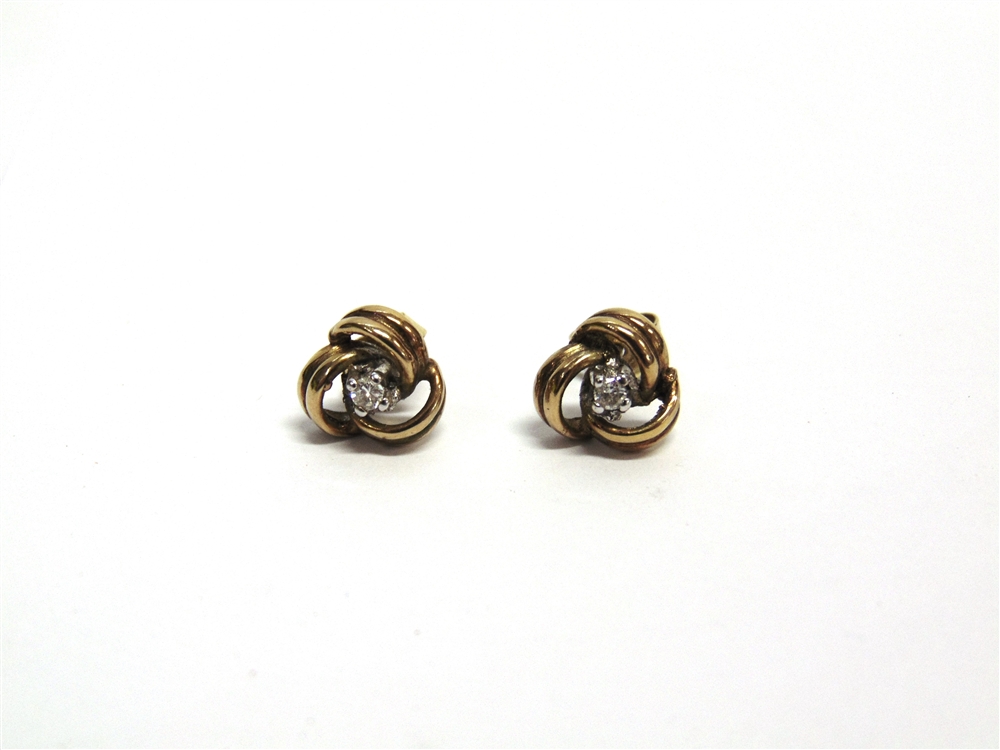 A PAIR OF GOLD AND SMALL DIAMOND KNOT STUD EARRINGS the round brilliant approximately 0.05cts,